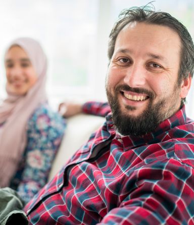 A refugee sitting at home with his partner