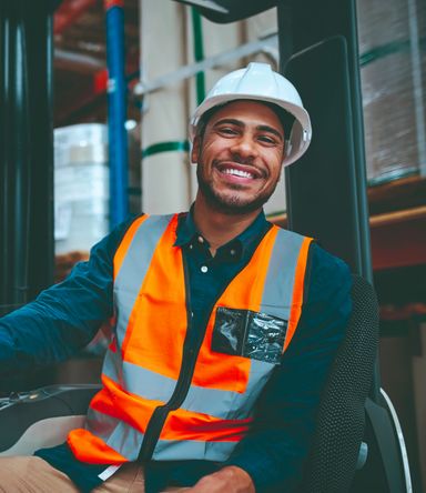 A smiling man working in a distribution centre
