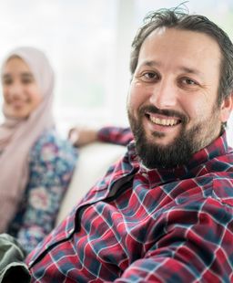 A refugee sitting at home with his partner